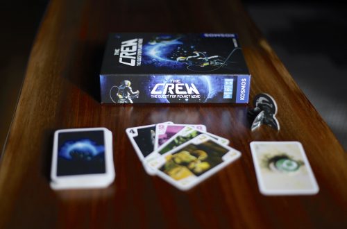 The Crew trick-taking card game box, cards, and pieces