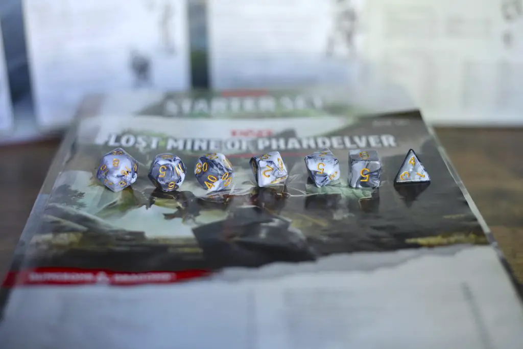 a set of gray polyhedral dice lined up in a row